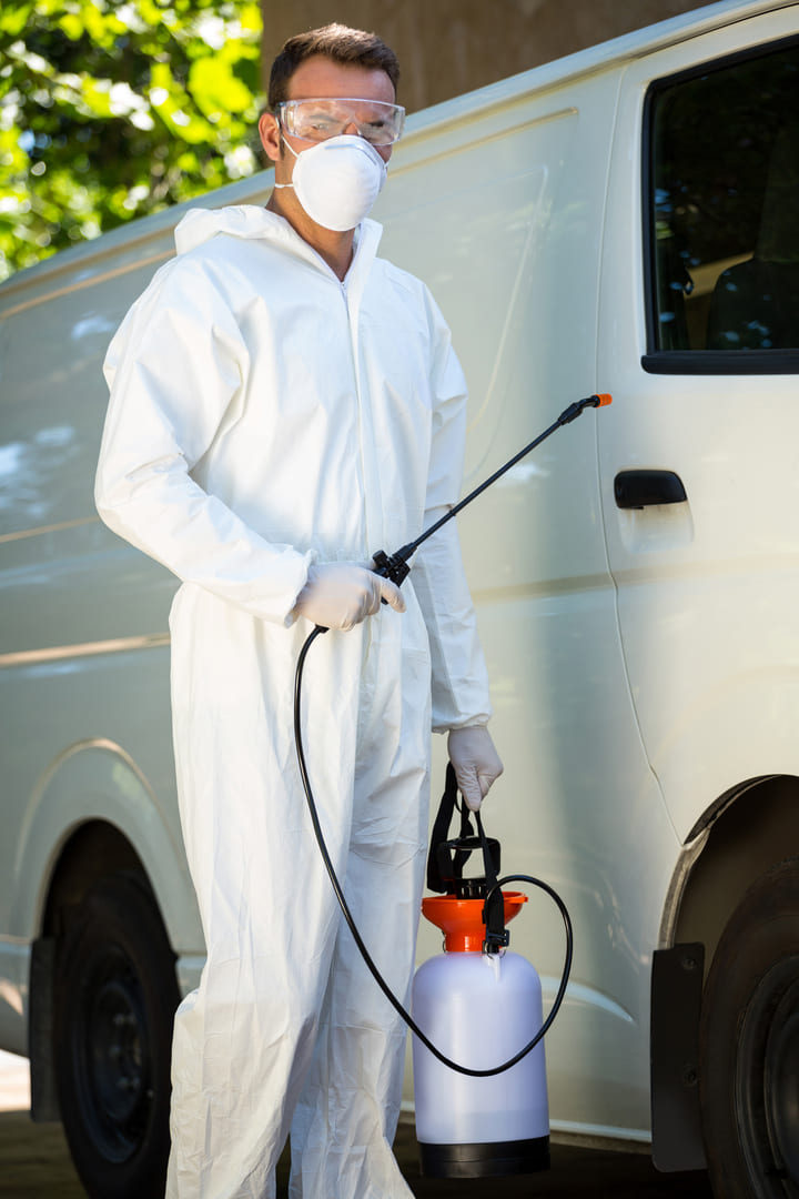 pest-control-man-standing-van